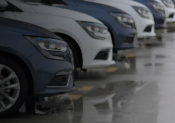 cars parked in a lot in a row in what is perhaps a rental company