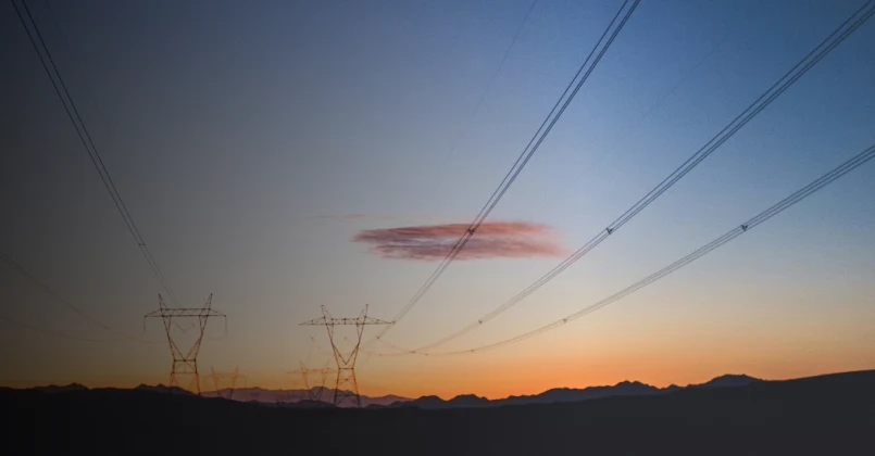 Sunset looking over electrical wires and towers.