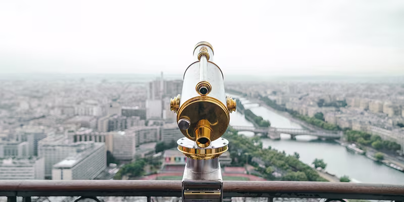 Gold and white telescope overlooking skyline