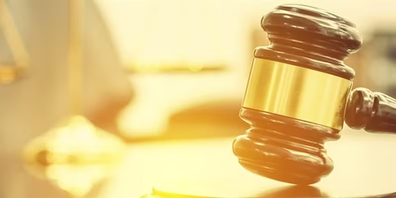 Image of a gavel with the sunlight reflecting off the background