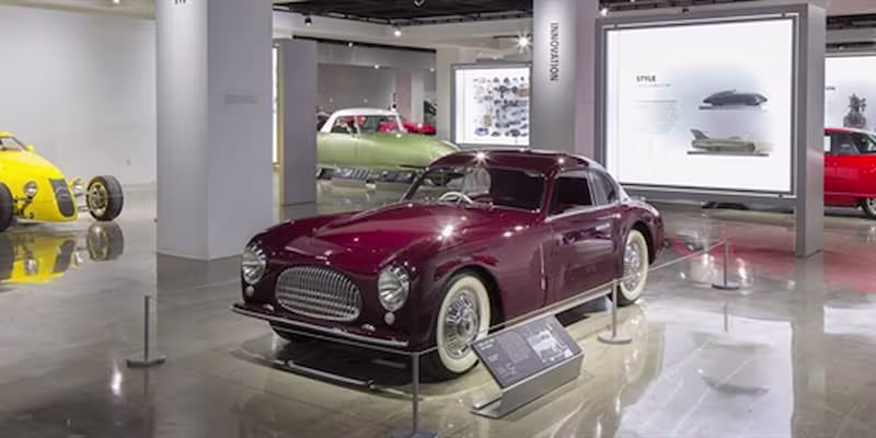 Car sales room with old red car