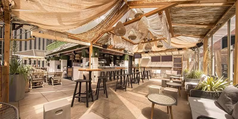 Photo of the event venue with tables and golden lighting