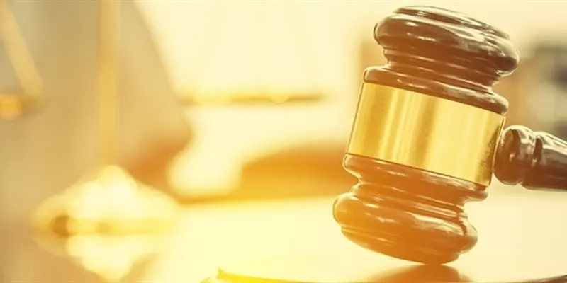 Image of a gavel with the sunlight reflecting off the background