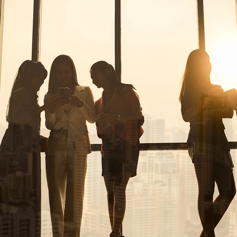 Silhouette diverse business people working over city background with double exposure