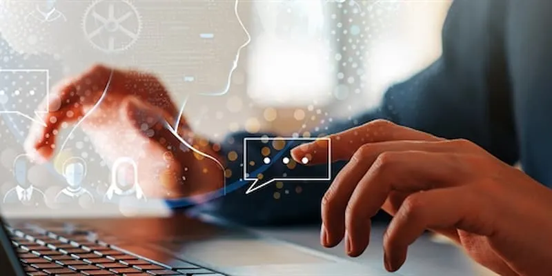 Hands typing on laptop with AI imagery above it