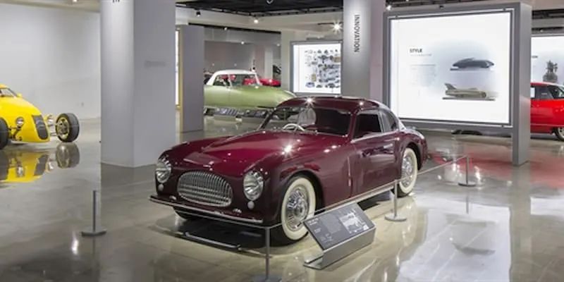 Car sales room with old red car
